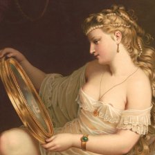 Krásná žena, prohlížející se v zrcadle.