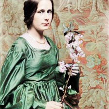 kolorovaná fotografie Žena s rozkvetlou větvičkou.